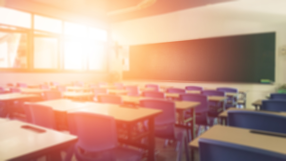 Empty classroom with the sun shining in a window